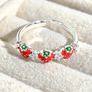 Close-up detail of sweet strawberry enamel open ring with sparkling zirconia stones.
