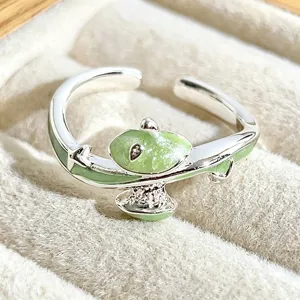 Detailed close-up of a cute green enamel and silver open ring, beautifully showcased.