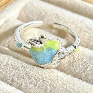 Close-up detail of the sweet apple enamel ring showing gradient blue and green colors.