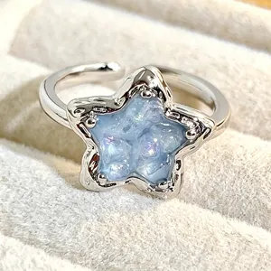 Closeup of the starry sky blue glitter adjustable ring, highlighting the detailed texture.