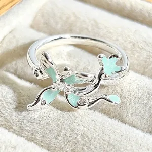Close-up detail of silver enamel ring featuring mint green sparkle finish and delicate rhinestone.