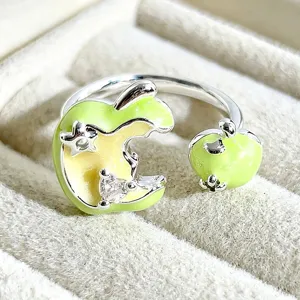 Close up detail of sweet cartoon fruit enamel open ring featuring green apple and zircon.
