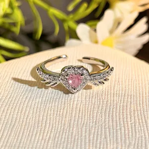 Close-up detail of the stunning pink heart zircon open ring with sparkling wing design.