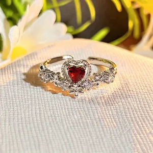 Close-up detail of the sparkling heart-shaped red gemstone ring with crystal rhinestones.