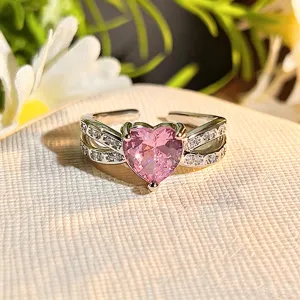 Close-up of exquisite pink heart zircon open ring with sparkling paved split band details.