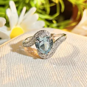 Exquisite heart-shaped blue zircon open ring with micro-pave stones, delicate style detail.
