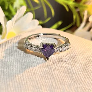 Detail shot of a stunning purple heart-shaped cubic zirconia open ring with sparkling stones.