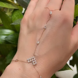 Detailed view of exquisite rose gold hand chain with sparkling cubic zirconia crystals.