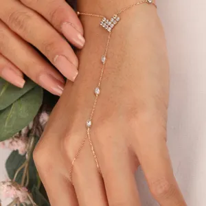 Exquisite heart rhinestone finger chain detail view, elegant rose gold slave bracelet for brides.
