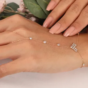 Delicate rose gold hand chain bracelet with sparkling zirconia details for bridal wedding use
