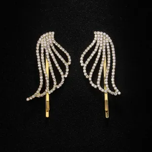 Detailed shot of sparkling rhinestone angel wing hair clips in gold finish for stylish girls.