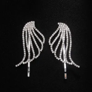 Close-up detail of sparkling rhinestone angel wing hair clip with shiny silver base.