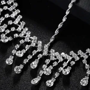 Rhinestone hair chain detail shot, sparkling crystal forehead jewelry for parties.
