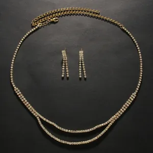 Rhinestone waist chain and dangle earrings detail, sparkling crystal bridal jewelry set.