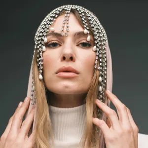 Detailed close-up shot of stunning rhinestone and pearl tassel hair chain headpiece for women.