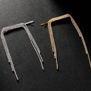 Close-up detail of rhinestone tassel hair clip featuring sparkling crystals and metal.