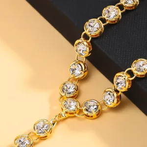 Exquisite rhinestone foot chain detail, golden metal sparkle design for summer beach style.