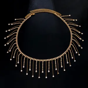 Gold rhinestone fringe waist chain detail, shiny crystal body chain for party festival wear.