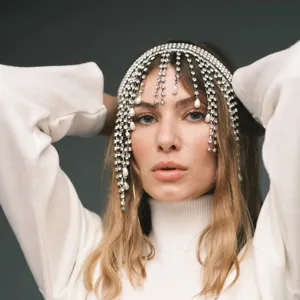 Close-up of sparkling rhinestone fringe hair chain with elegant pearl detail for party.