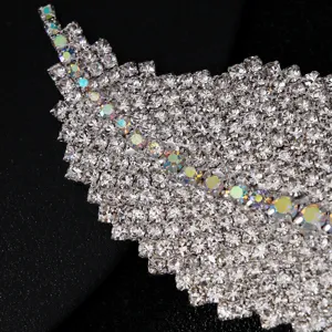 Exquisite rhinestone feather hair clip detail, sparkling crystals for elegant side wear.