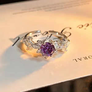 Detail shot of purple zircon floral open ring, sterling silver color, sparkling design.