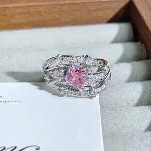 Close-up detail of silver open ring featuring a sparkling square pink zircon and pave stones.