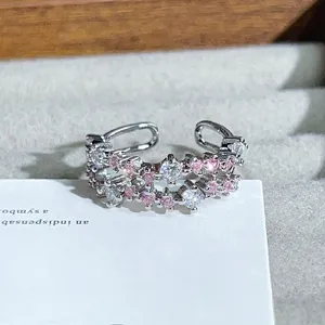 Close-up detail of double-band open ring featuring sparkling pink and clear cubic zirconia.