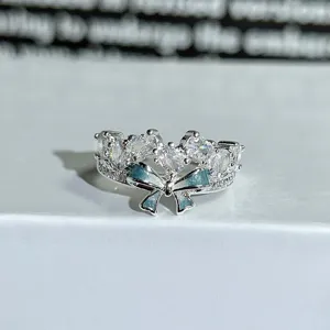 Detail shot of a stunning silver bow ring adorned with sparkling zirconia and blue enamel.