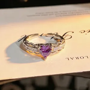 Detailed close-up view of the hollow heart-shaped purple zirconia open ring design.