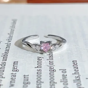 Silver open ring featuring a sparkling pink heart zircon and side stones, chic and stylish.