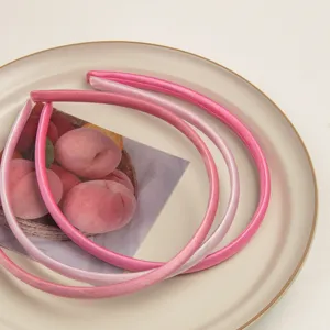 Gros plan détaillé de serre-tête en satin rose élégamment présentés sur une assiette pour femmes.