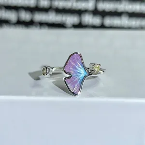Close-up detail of the colorful enamel ginkgo butterfly open ring with sparkling zircon.