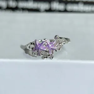 Close-up of a silver open ring with purple enamel starfish design, delicate style for daily wear.