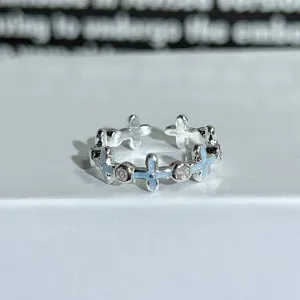 Silver open ring with light blue enamel flower motifs and sparkling zircons for daily wear.