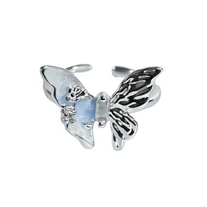 Exquisite butterfly open ring detail, asymmetrical blue and black enamel with center zircon.