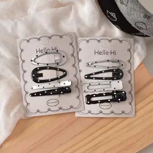 Close-up of cute sweet cool polka dot BB hair clips on display cards with fine glitter.