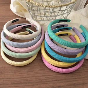 Detailed view of colorful striped sponge headbands, featuring stylish design and soft fabric.