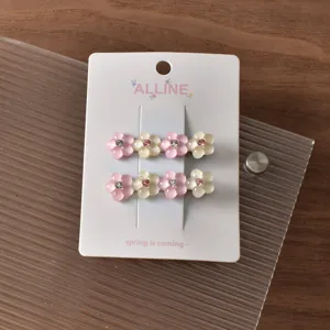 Floral hairpin detail showing pink and white resin flowers with sparkling rhinestones.