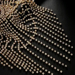 Gros plan sur la chaîne de cheveux à franges en strass dorés, détail de coiffe de mariée.
