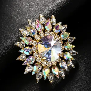Exaggerated rhinestone ring closeup detail showing sparkling iridescent colorful crystal stones on gold.