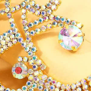 Exotic rhinestone leg chain detail, dazzling AB crystal metal belly dance body jewelry.
