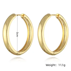 Detailed close-up view of thick gold hoop earrings highlighting 3cm size and 11.1g weight.