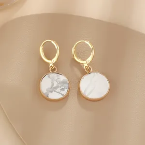 Gold-rimmed marble pattern round drop earrings, minimalist French style fashion jewelry.
