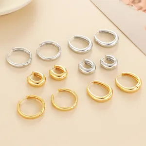 Set of minimalist gold and silver hoop earrings, classic round geometric huggie designs for women.