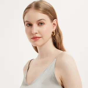 Minimalist gold chunky hoop earrings worn by model, elegant and stylish everyday jewelry.