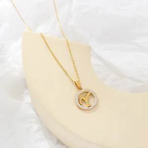 Gold letter Y pendant necklace close-up, delicate rhinestone circle detail on beige prop display.