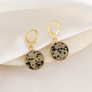 Detailed shot of elegant gold-plated hoop earrings featuring natural stone round drop pendants.