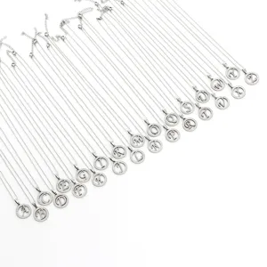 Detail view of 26 alphabet letter pendant necklaces in silver tone with sparkly rhinestone circle.