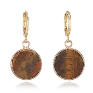 Detail view of vintage gold leverback earrings featuring natural tiger eye stone round pendants.