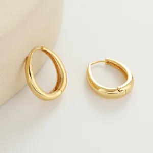 Detail shot of elegant minimalist gold hoop earrings featuring a smooth teardrop design.